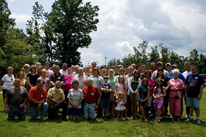 The extended family gathered outdoors on the grass for the 2009 reunion.