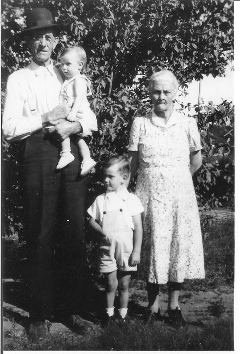Charles Hubbard Sanders and Sadie with two young grandsons, Herb and Chuck.