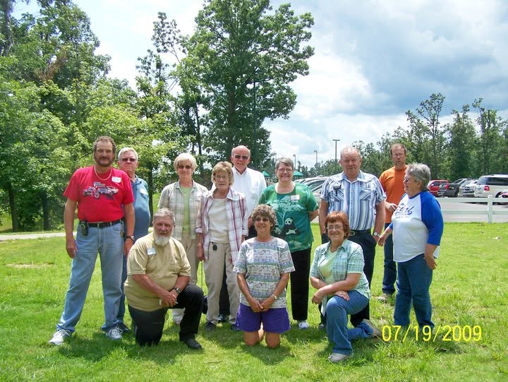 A group of cousins posing together outdoors.