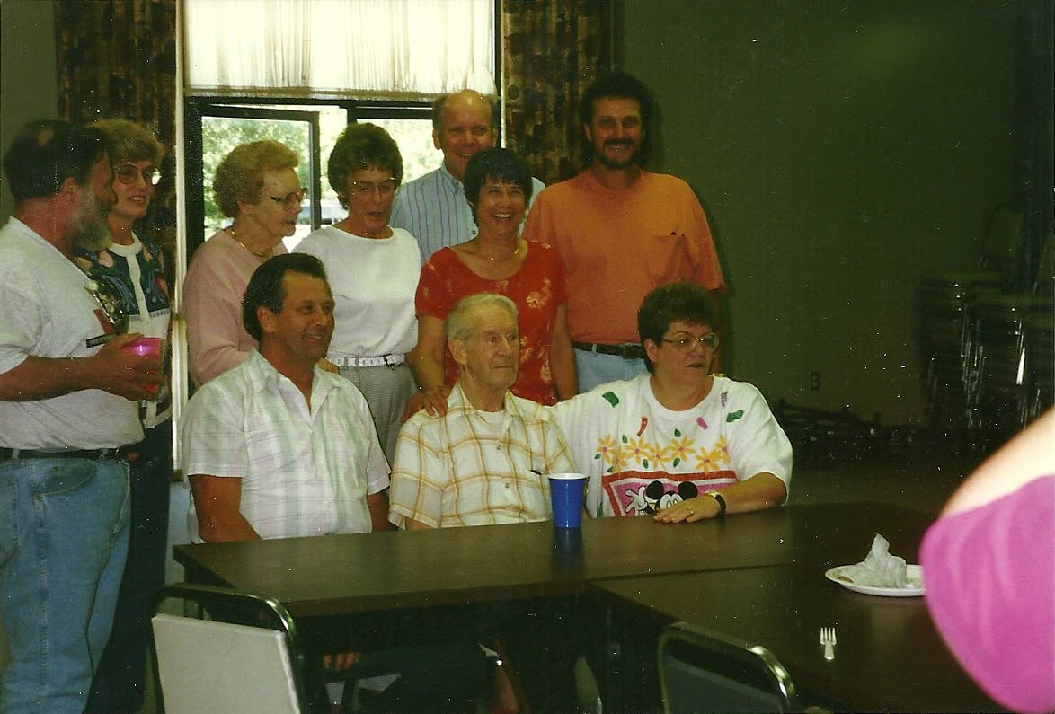 Lawson Sanders with several of his nieces and nephews gathered around a table.